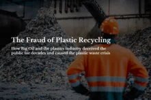Worker in orange work clothes in front of waste recycling machine