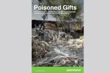 River flowing through a garbage dump. Simple huts in the background. Title: Poisoned Gifts. From donations to the dumpsite: textiles waste disguised as second-hand clothes exported to East Africa.