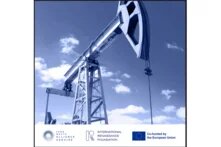 Crane in an oil production facility against a blue sky