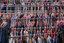 Clothes on plastic hangers on racks